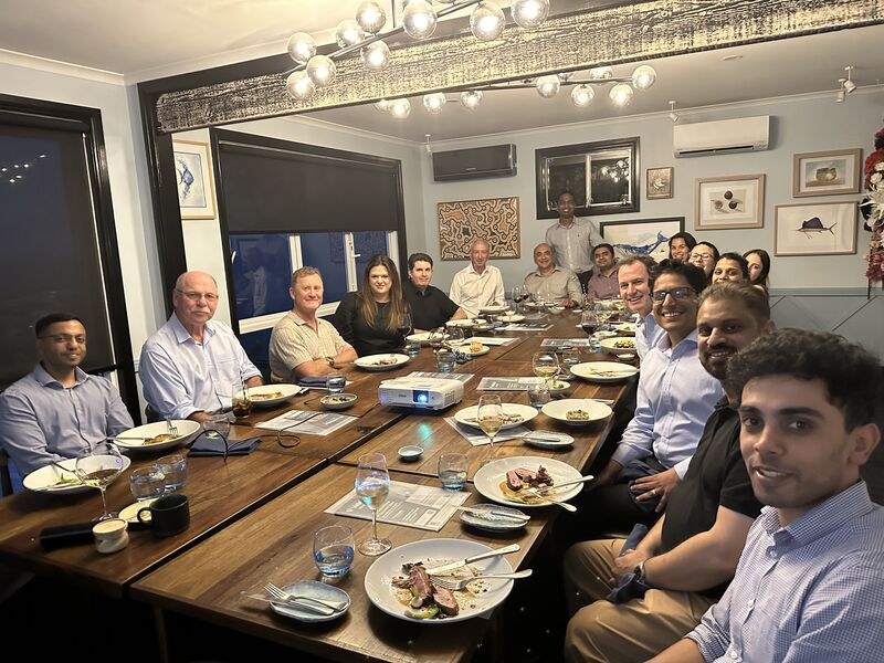 Gastroenterologists and trainees from the Central Coast around a long table at an evening education meeting