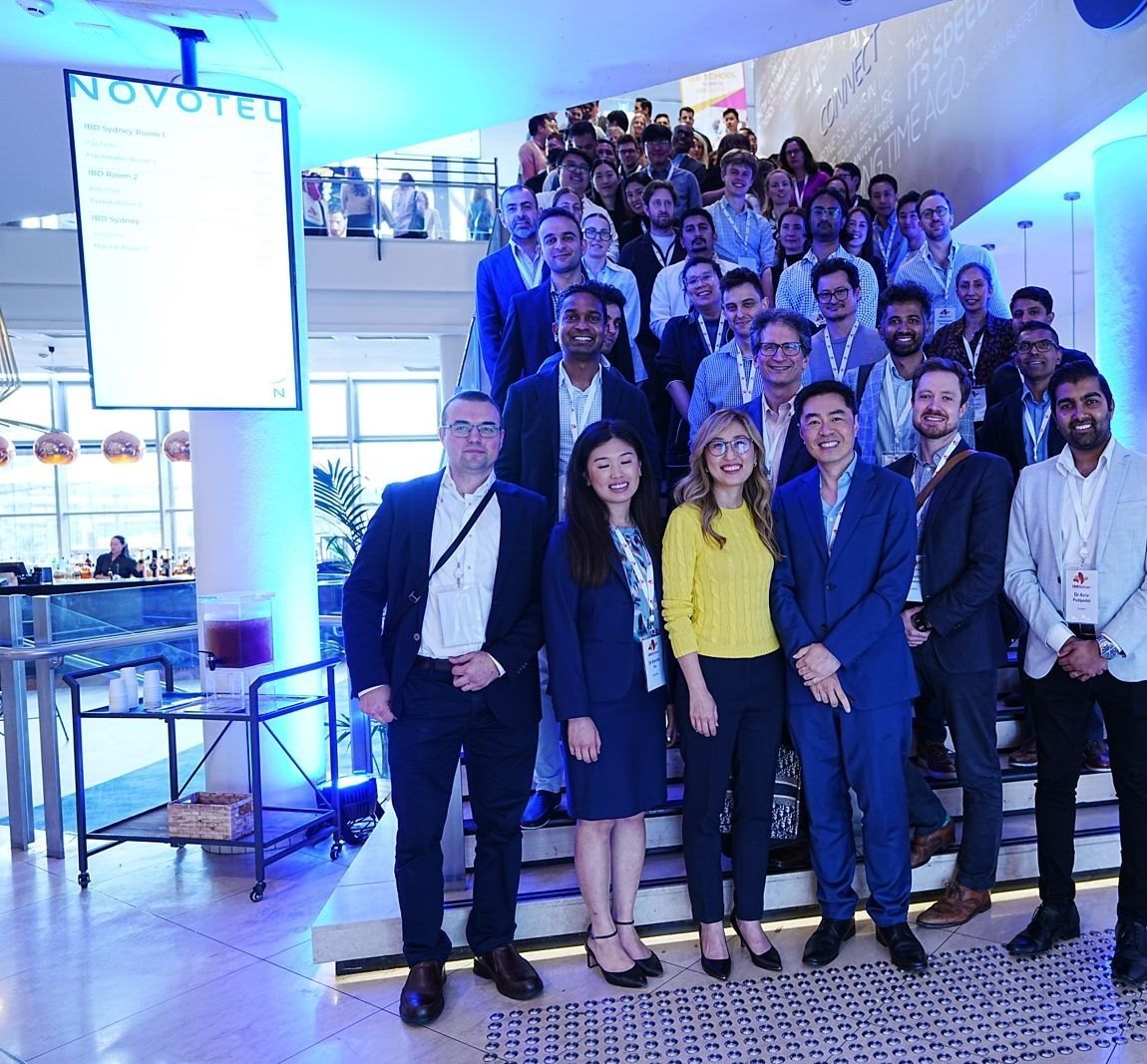 Delegates and faculty of IBD School 2025 gathered on a staircase at the end of the course